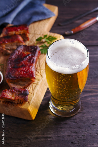 Beer and pork spare ribs. Beer and meat. Glass of ale