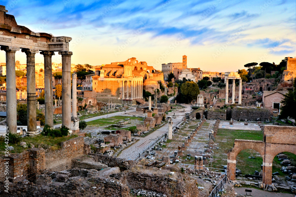 View over the ancient Roman Forum at sunset with orange and blue skies, Rome, Italy