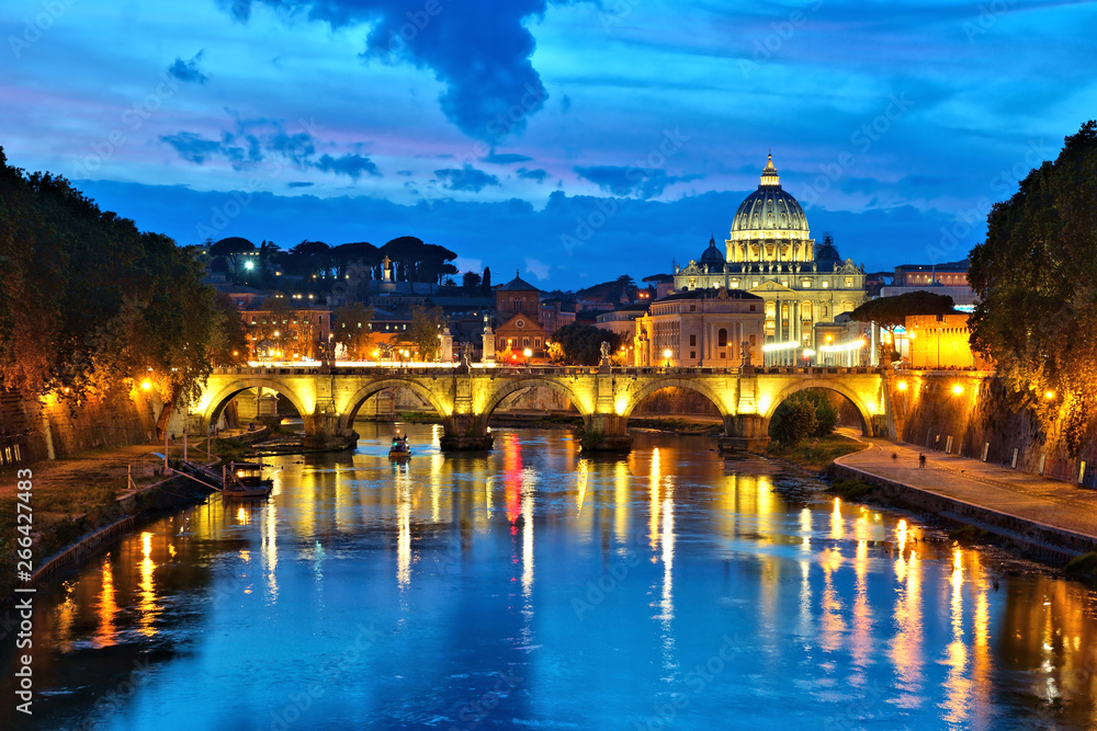 View of Vatican City across the River Tiber with illuminated reflections, Rome, Italy