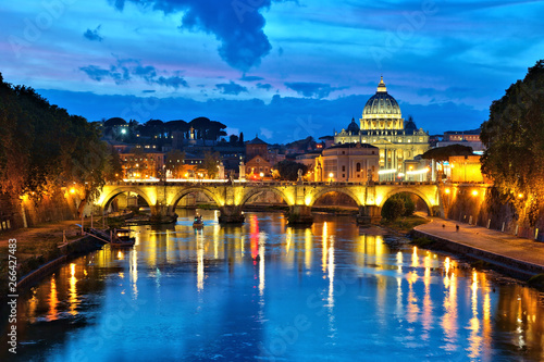 View of Vatican City across the River Tiber with illuminated reflections, Rome, Italy