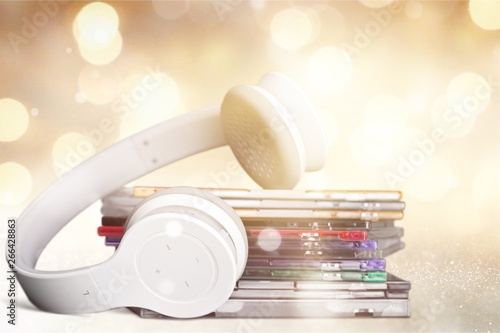 Headphones and compact discs isolated on background