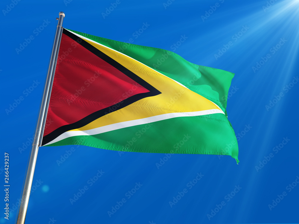Guyana National Flag Waving on pole against deep blue sky background. High Definition Guyana National Flag Waving on pole against deep blue sky background. High Definition