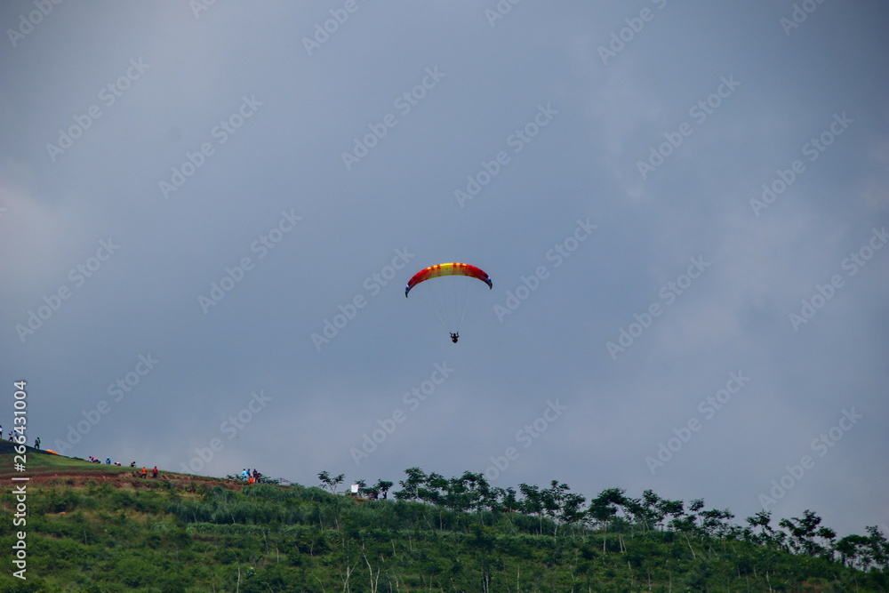 Paragliding athletes while competing in the national championship, flying from a Sikuping hill in Batang Central Java Paragliding athletes while competing in the national championship, flying from a Sikuping hill in Batang Central Java