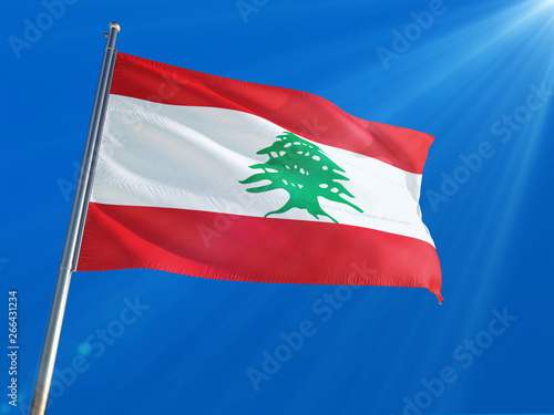 Lebanon National Flag Waving on pole against deep blue sky background. High Definition