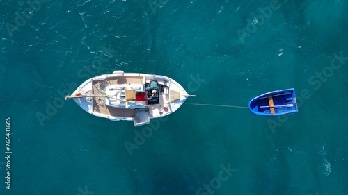 Aerial top view photo of traditional fishing boat docked in paradise bay of Elafonisi with turquoise clear sea, Crete island, Greece