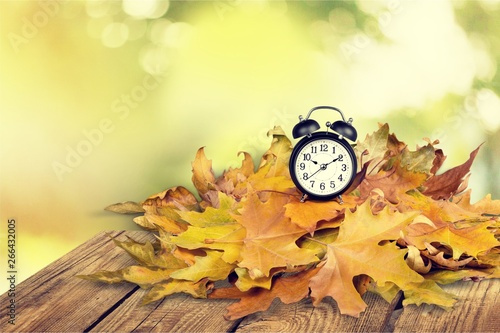 Retro alarm clock on table background