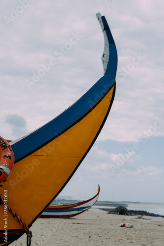 Typical colourful Moliceiro fishing boats on the beach in Espinho, Portugal photo