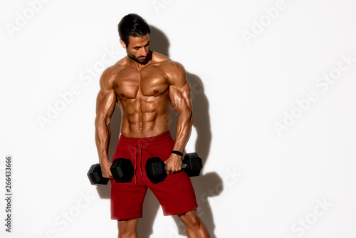 Handsome Male Fitness Model Exercise With Weights © mrbigphoto