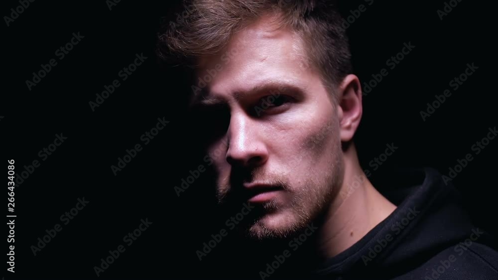 Disappointed man looking into camera isolated on black background stress concept Disappointed man looking into camera isolated on black background stress concept
