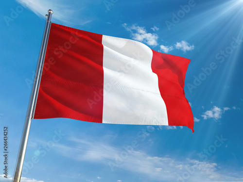Peru National Flag Waving on pole against sunny blue sky background. High Definition