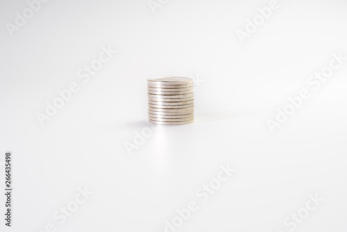 Stack of silver coins isolated on white background, industry