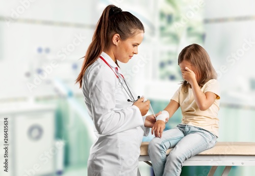 Young woman doctor with little girl in a hospital