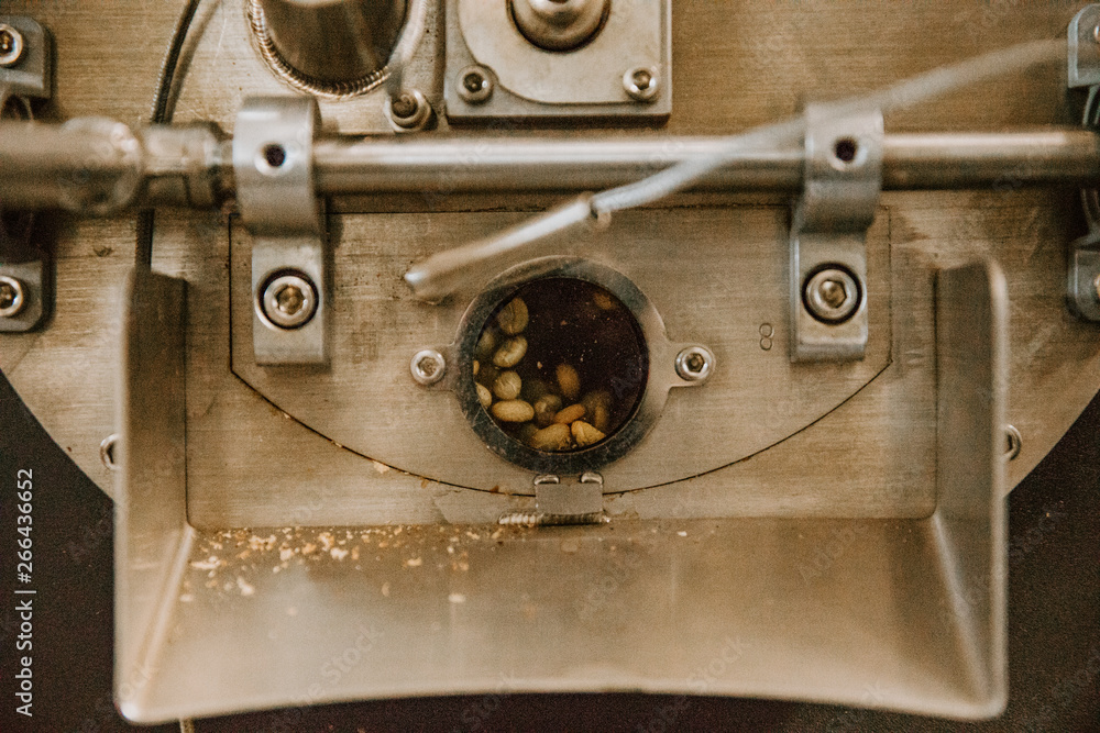 Organic Coffee Beans Roasting in an Industrial Coffee Bean Roaster and Cooling on Mechanical Stirring Pan Organic Coffee Beans Roasting in an Industrial Coffee Bean Roaster and Cooling on Mechanical Stirring Pan
