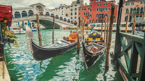 Empty gondolas in front of Rialto Bridge. The bridge is a famous international landmark in Venice, Italy © CrackerClips