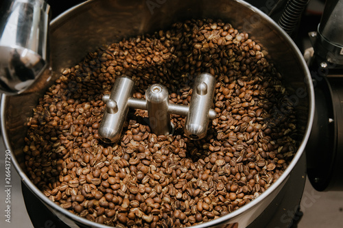 Organic Coffee Beans Roasting in an Industrial Coffee Bean Roaster and Cooling on Mechanical Stirring Pan