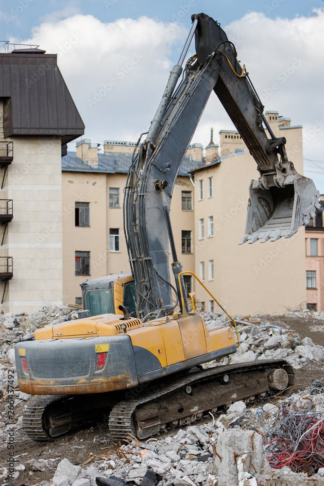 Building of the former hotel demolition for new construction, using a special hydraulic excavator-destroyer. Dismantling of house. Building of the former hotel demolition for new construction, using a special hydraulic excavator-destroyer. Dismantling of house.