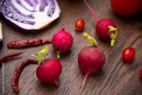 red vegetables set on woode...