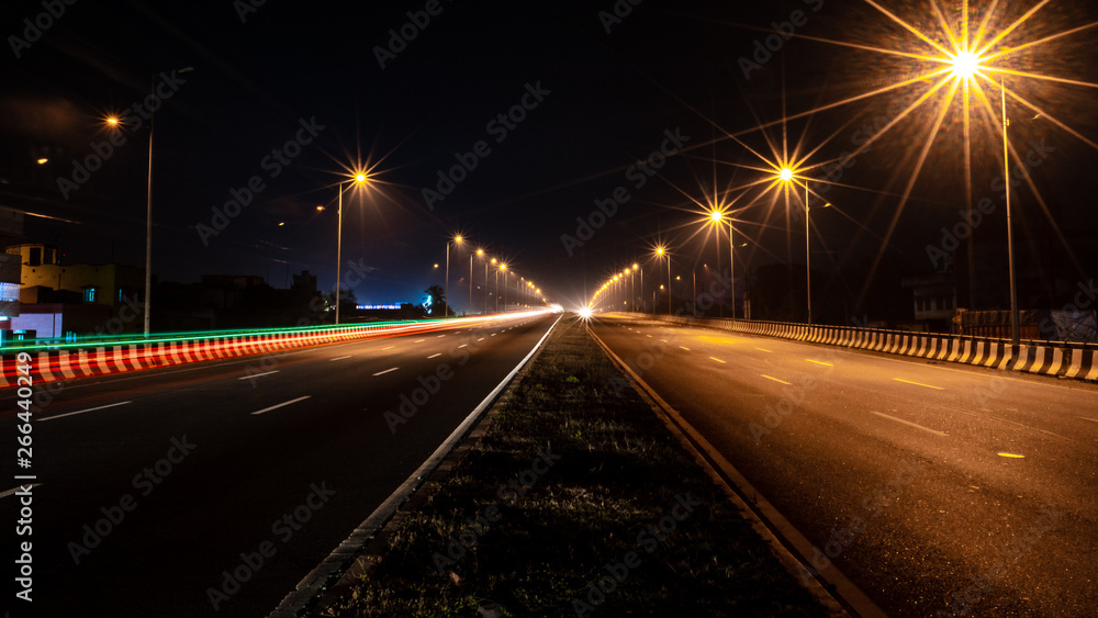 Fast driving vehicles trial at night, with long exposure blurred effect at Indian Nation Highway 2.