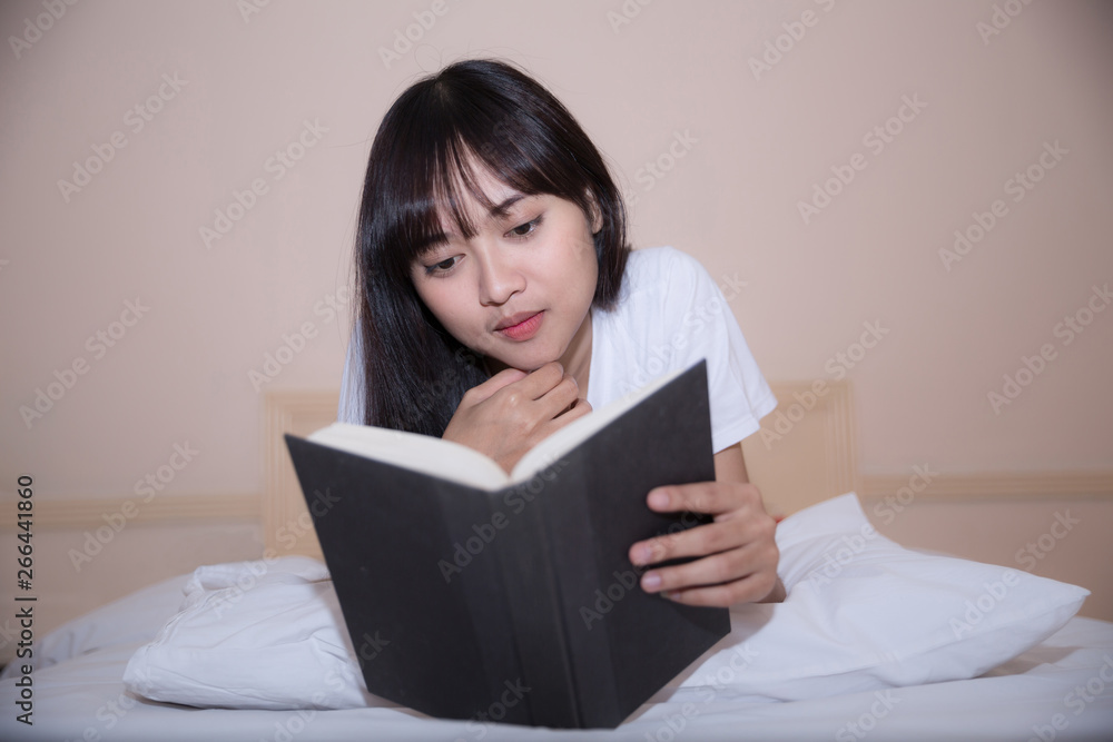 girl reading book and drinking coffee in bed in the morning girl reading book and drinking coffee in bed in the morning