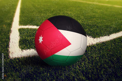 Jordan ball on corner kick position  soccer field background. National football theme on green grass.