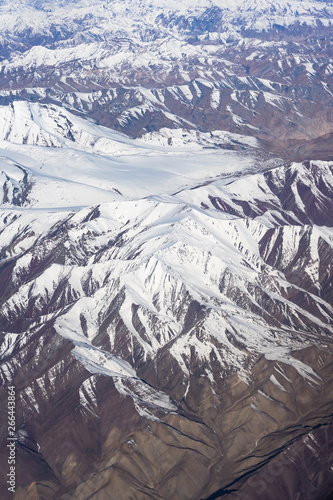 Himalaya mountains under clouds. View from the airplane, ladakh, Jammu and Kashmir, india photo