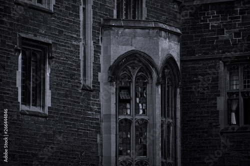 Toronto, Canada - 20 10 2018: Interior of the historic Hart House building in the University of Toronto with columns and stairway with some light beams in dark surrounding photo