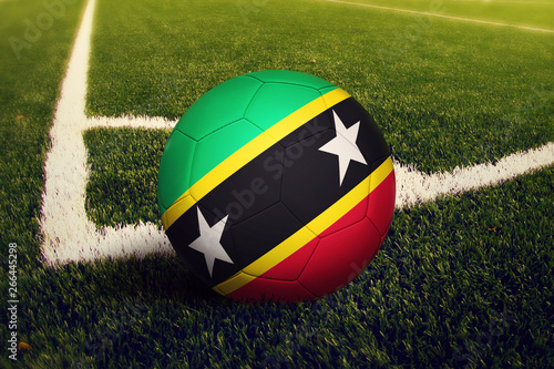 Saint Kitts And Nevis ball on corner kick position, soccer field background. National football theme on green grass.