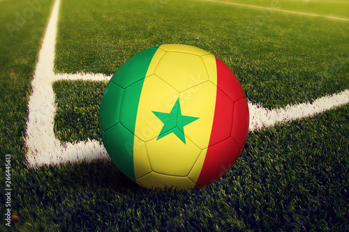 Senegal ball on corner kick position  soccer field background. National football theme on green grass.