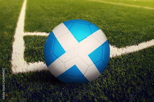 Scotland ball on corner kick position  soccer field background. National football theme on green grass.