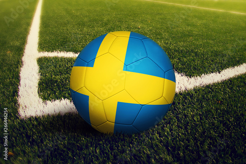Sweden ball on corner kick position  soccer field background. National football theme on green grass.