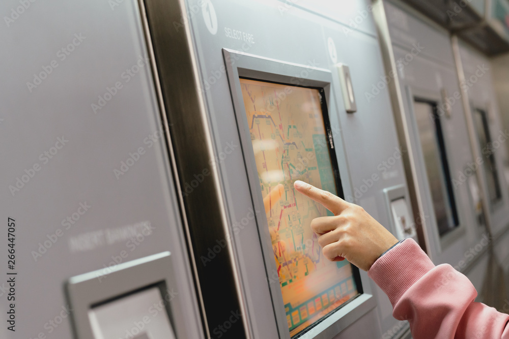 Woman choosing the destination on subway train ticket machine. Transportation concept Woman choosing the destination on subway train ticket machine. Transportation concept