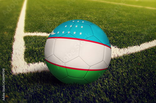 Uzbekistan ball on corner kick position  soccer field background. National football theme on green grass.