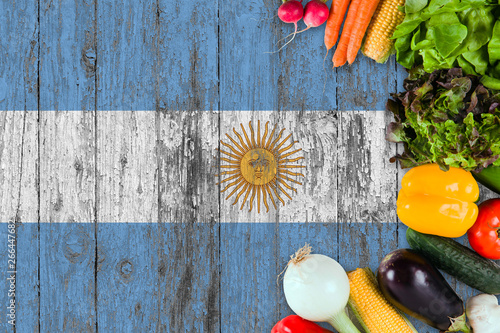 Fresh vegetables from Argentina on table. Cooking concept on wooden flag background.