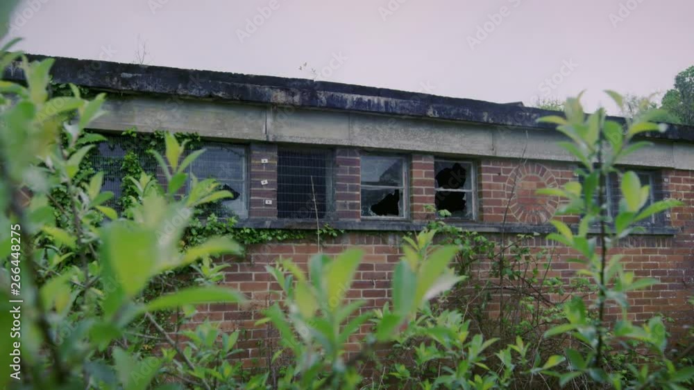 Handheld panning shot of old abandoned factory with broken windows, 4K slow mo Handheld panning shot of old abandoned factory with broken windows, 4K slow mo
