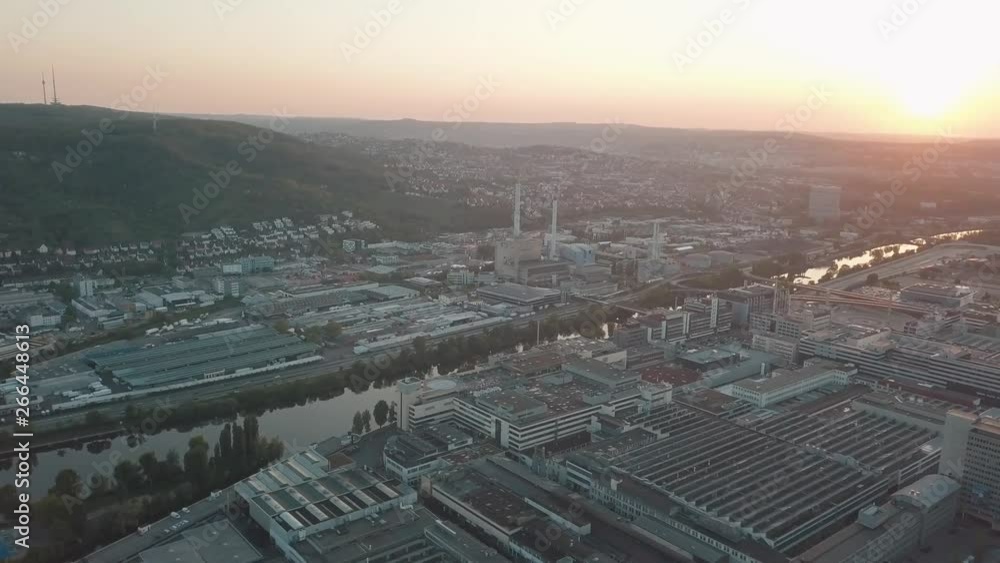 Aerial drone shot of beautiful Stuttgart, Germany while sunset with the Mercedes Benz Arena, the famous Volksfest Wasen and a lot of industry in the foreground and Stuttgart Downtown in the background Aerial drone shot of beautiful Stuttgart, Germany while sunset with the Mercedes Benz Arena, the famous Volksfest Wasen and a lot of industry in the foreground and Stuttgart Downtown in the background