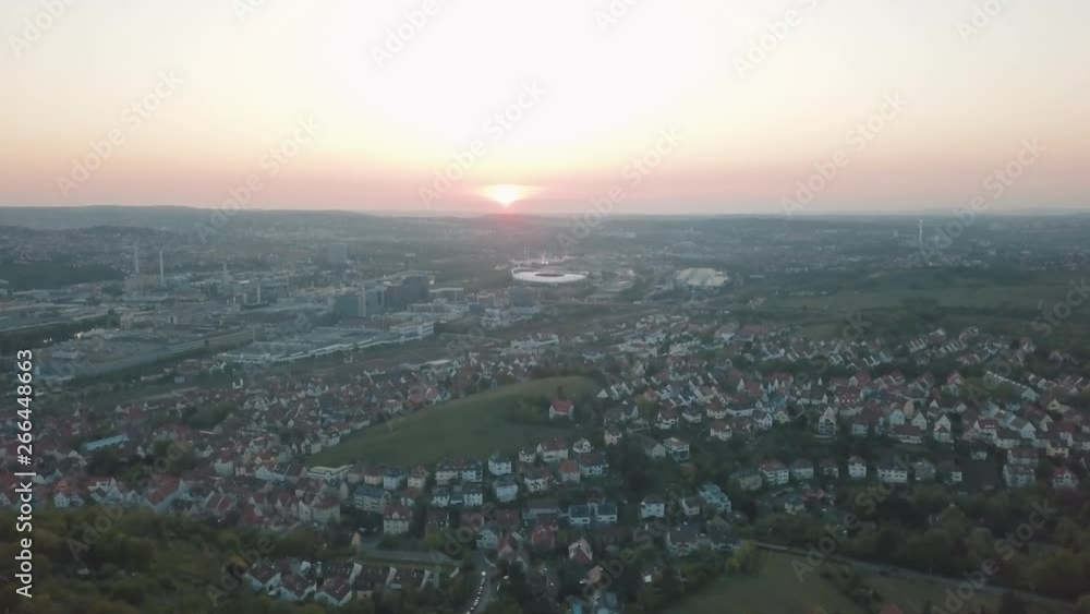 Aerial drone shot of beautiful Stuttgart, Germany while sunset with the Mercedes Benz Arena, the famous Volksfest Wasen and a lot of industry in the foreground and Stuttgart Downtown in the background Aerial drone shot of beautiful Stuttgart, Germany while sunset with the Mercedes Benz Arena, the famous Volksfest Wasen and a lot of industry in the foreground and Stuttgart Downtown in the background