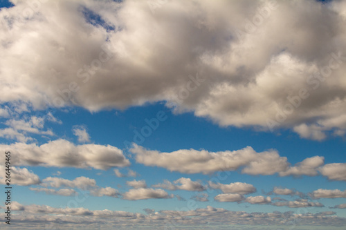 Sky of abundant white clouds and celestial spaces. Cottony clouds distributed throughout the sky.