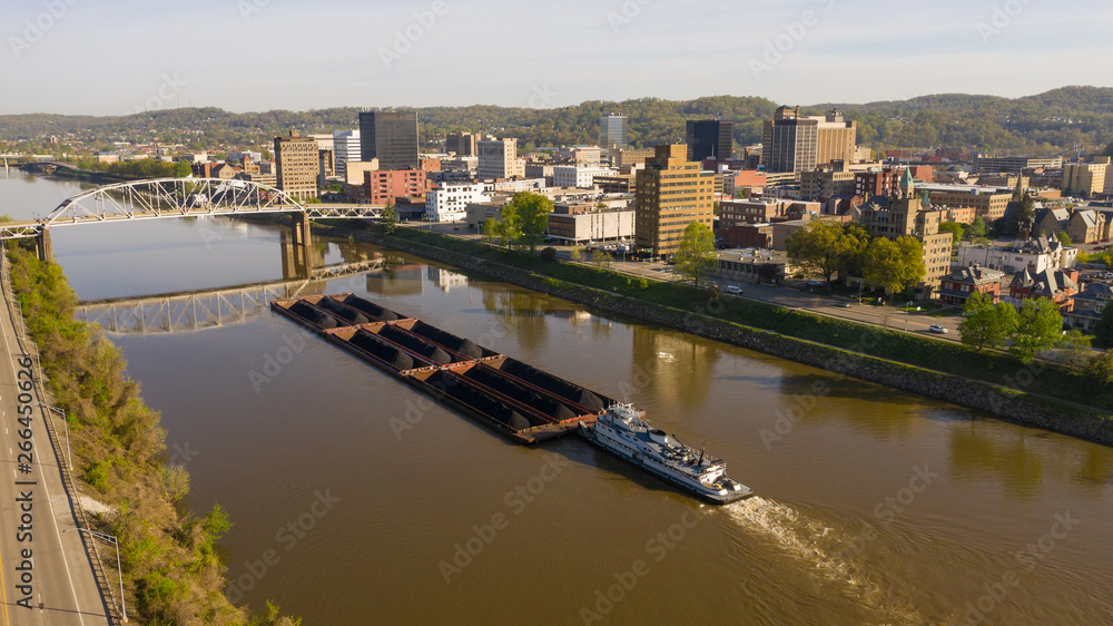 Barge Pushes Resources Down the River in Front of Charleston West Virginia