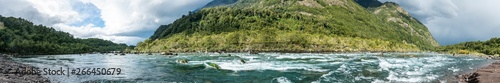 An amazing landscape at north Chilean Patagonia, Petrohue river moves around the volcanic lava flows of Osorno Volcano on an awe idyllic natural environment outdoor scenery. White waters for rafting