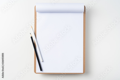 white flipped paper on clipboard isolated on white © voyata