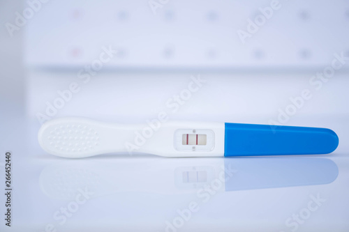 Closeup pregnancy test with calendar background, health care concept, selective focus