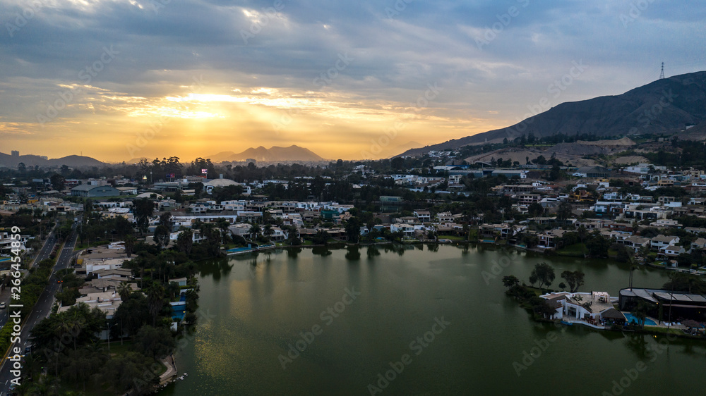 Lima, Perú - May 4 2019:  Aerial view of Las Lagunas in La Planicie. Lake at sunset with houses of high class.