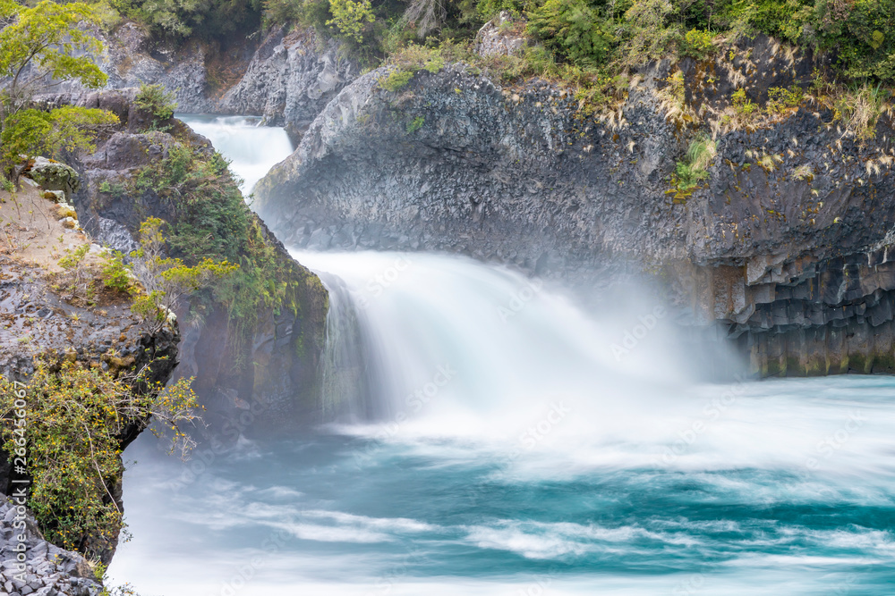 Fototapeta premium An amazing landscape at north Chilean Patagonia, Petrohue river moves around the volcanic lava flows of Osorno Volcano on an awe idyllic natural environment outdoor scenery. White waters for rafting 