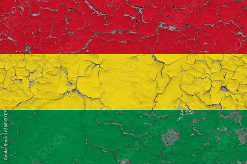 Flag of Bolivia painted on cracked dirty wall. National pattern on vintage style surface.