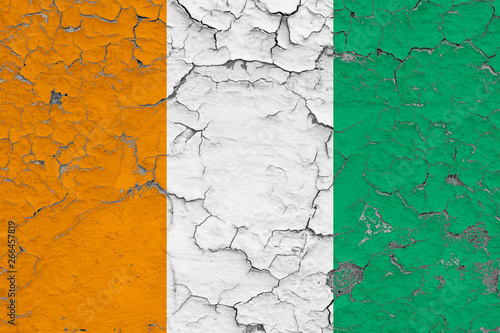 Flag of Cote D'Ivoire painted on cracked dirty wall. National pattern on vintage style surface.