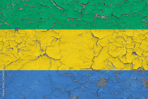 Flag of Gabon painted on cracked dirty wall. National pattern on vintage style surface. © sezerozger