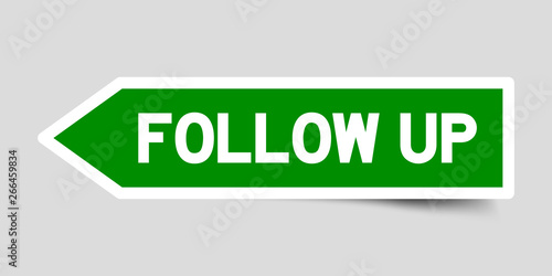 Green color arrow sticker with word follow up on gray background