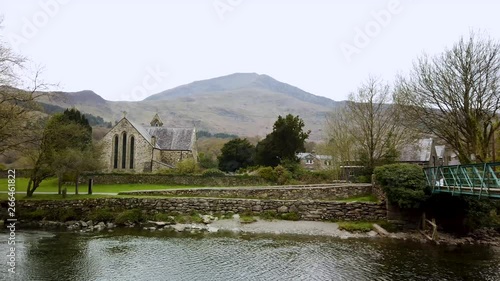 River Glaslyn, Beddgelert, North Wales, UK - showing the mountain Moel Hebog in the background and the Church of St Mary. photo