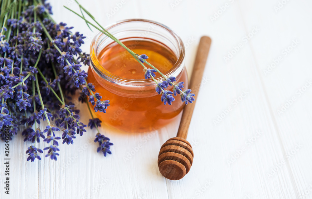 Jar with honey and fresh lavender flowers Jar with honey and fresh lavender flowers