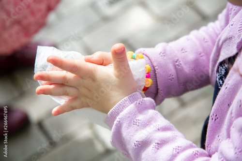 baby s palm with a damp napkin, child cares for purity. Photo of children's palms.